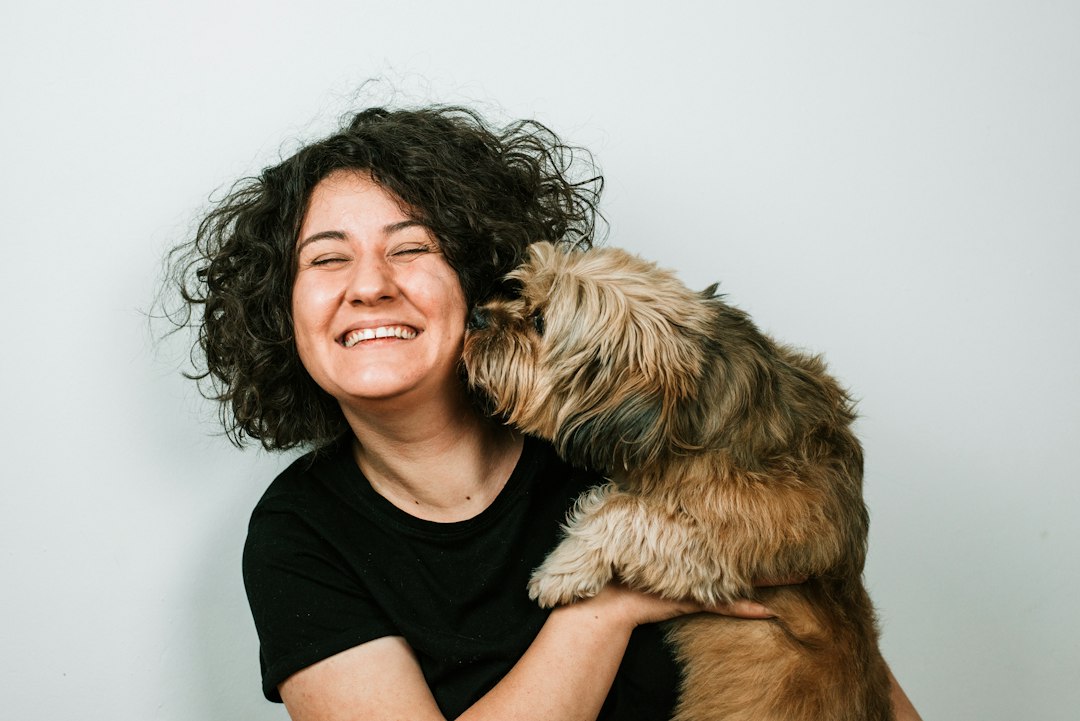 panic disorder support animals — dog kissing woman in black crew-neck shirt
