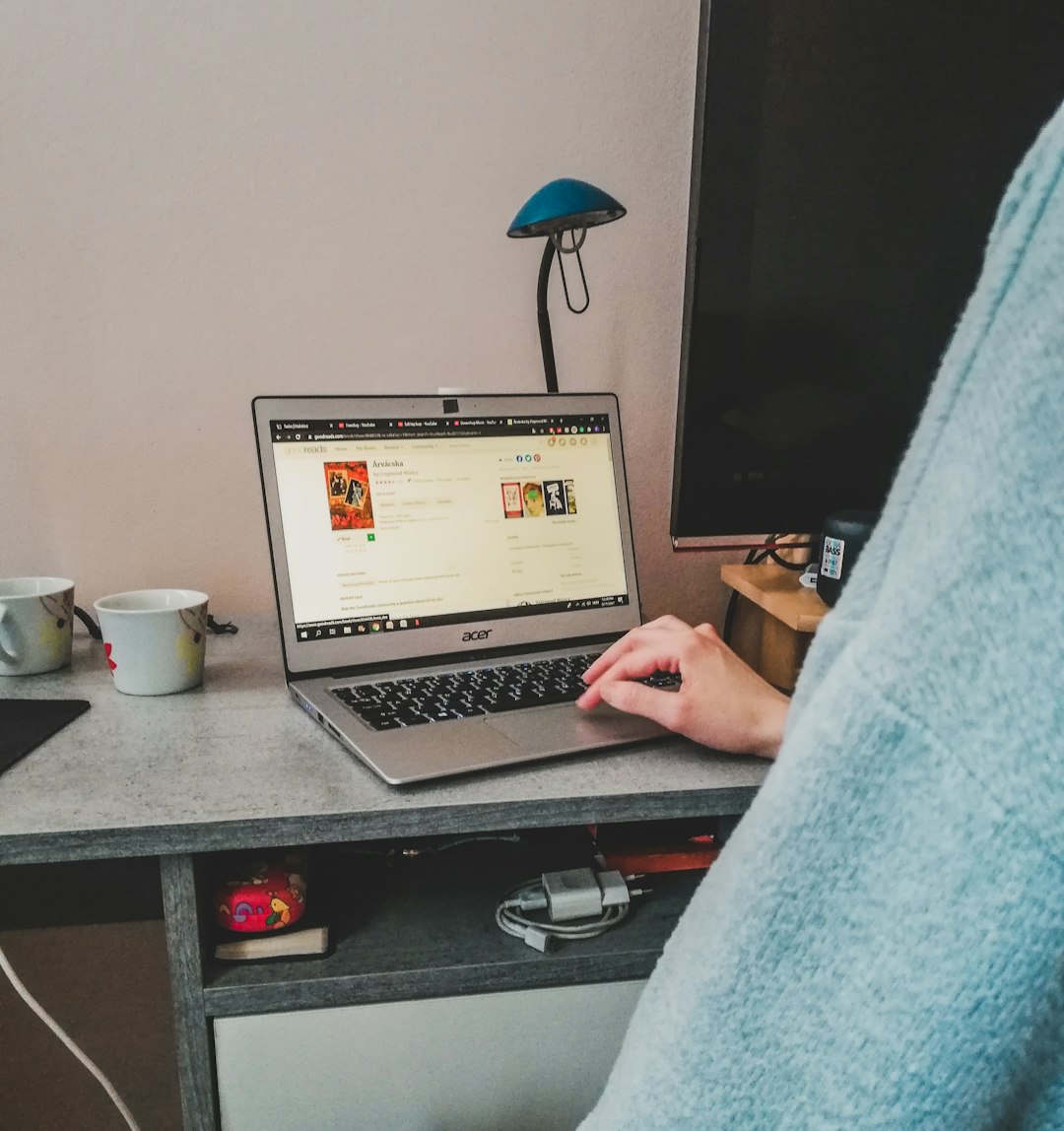 clinician support animal — a person sitting in front of a laptop computer